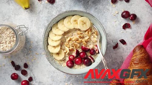 Ceramic Bowl of Oatmeal Porridge with Banana Fresh Cranberries and Walnuts 32772661