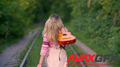 MotionArray – Woman With Guitar Walks On Railway 1026440