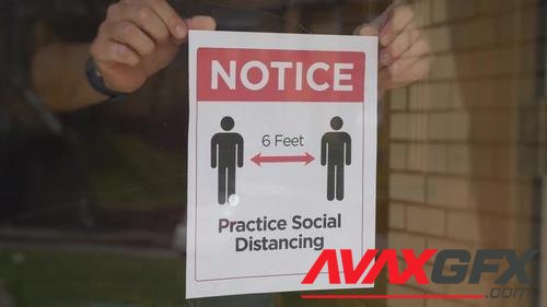 MotionArray – Man Puts Social Distance Sign On Door 1024370