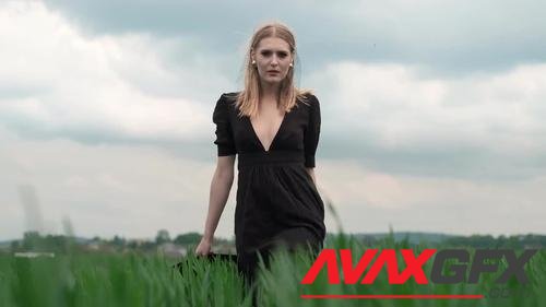 MotionArray – Blonde Woman Walking Through Grass 823021