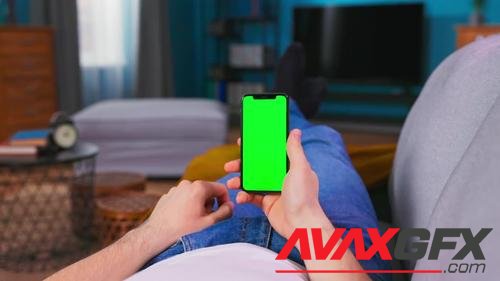 MotionArray – Man Scrolls Finger On Phone Green Screen 997872