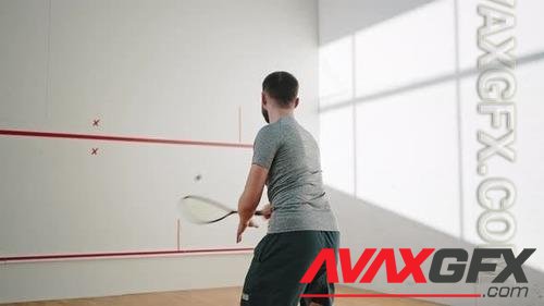 Athlete in Good Shape Hits Ball with Racket Against Wall 41146966