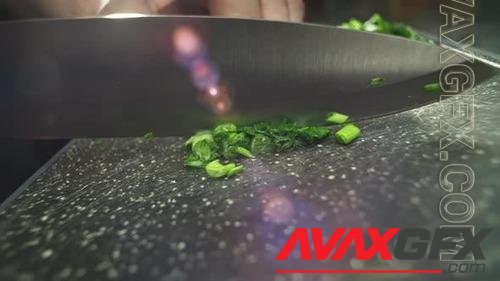 Slow Motion Closeup Video of Slicing Green Onions on a Cutting Board 41145338
