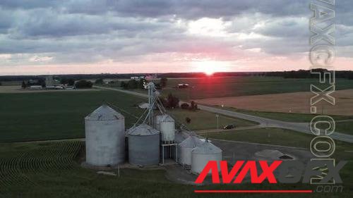 Farm silo with American flag waving on top during sunset in rural Michigan with drone video moving i 40148291
